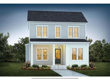 Charming two-story home with inviting front porch, well-manicured lawn, and beautiful landscaping at 723 Rambling Leaf Ln, Summerville, SC 29486