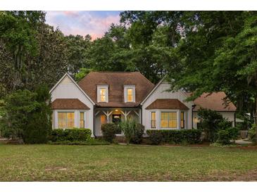Charming home featuring a well-manicured lawn and mature trees, providing a welcoming curb appeal at 1019 Royalist Rd, Mount Pleasant, SC 29464