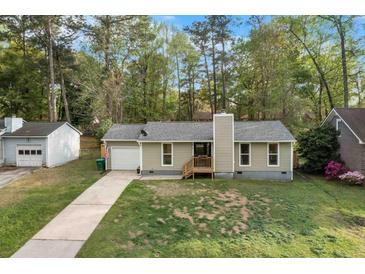 Charming single-story home featuring a well-maintained lawn, attached garage, and a cozy front porch entry at 109 Sawmill Dr, Summerville, SC 29483