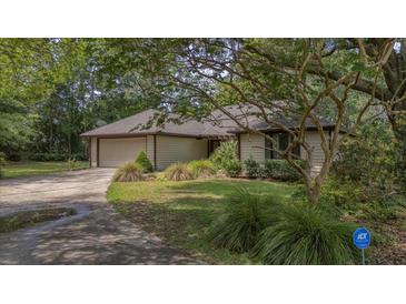 Charming single-story home with a well-manicured lawn, mature trees, and a convenient attached two-car garage at 1129 Belvedere Ter, Mount Pleasant, SC 29464