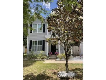 Charming two-story home with gray siding, black shutters, and a well-manicured lawn at 1199 Landau Ln, Mount Pleasant, SC 29466