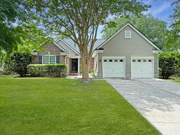 Charming single Gathering home featuring a brick facade, a two car garage, and a lush green lawn at 1317 Wild Olive Dr, Mount Pleasant, SC 29464