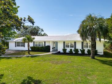 Beautifully landscaped single-story home with a well manicured lawn and elegant walkway at 1467 Battalion Dr, James Island, SC 29412