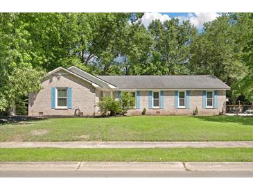 Charming single-story brick home featuring blue shutters and mature trees surrounding the landscaped front yard at 1673 Sulgrave Rd, Charleston, SC 29414