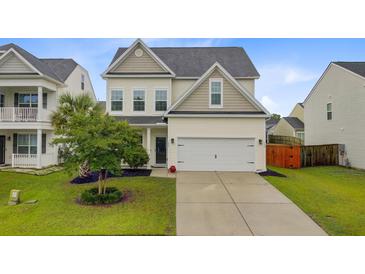 Charming two-story home with a well-manicured lawn and a two-car garage at 192 Weeping Cypress Dr, Moncks Corner, SC 29461