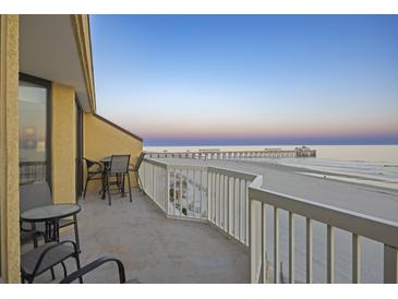 Lovely balcony with seating and beautiful ocean view perfect for relaxing and enjoying the sunrise at 201 W Arctic Ave # 406, Folly Beach, SC 29439