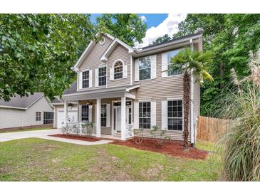 Charming two-story home with a well-manicured lawn and a welcoming front porch at 206 Hawkridge Pl, Goose Creek, SC 29445