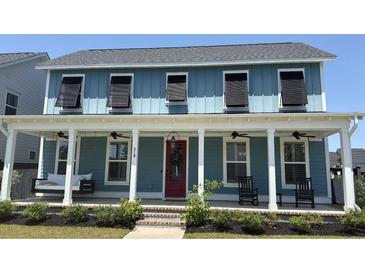 Charming blue two-story home with a welcoming front porch, swing, and red front door at 318 Ripple Park Dr, Summerville, SC 29486