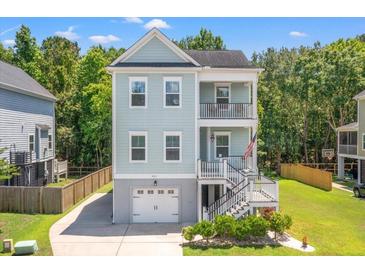 Charming two-story home with double balconies and lush landscaping surrounded by green trees at 3751 Copahee Sound Dr, Mount Pleasant, SC 29466