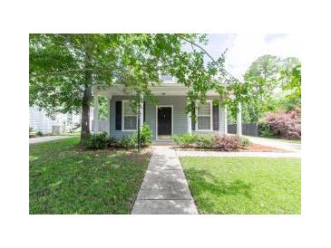 Charming home with mature trees, a sidewalk to front door, and manicured lawn at 4818 Holly Berry Ln, Summerville, SC 29485