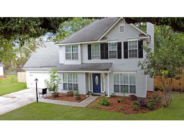 Charming two-story home with symmetrical design, black shutters and a well-manicured lawn and garden at 709 Black Oak Blvd, Summerville, SC 29485
