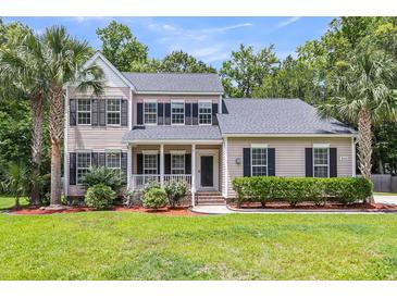 Charming two-story home with a welcoming porch and well-maintained landscaping at 8166 Scottswood Dr, North Charleston, SC 29418