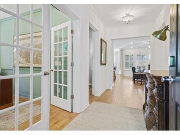 Bright foyer with hardwood floors leading to a study with French doors and an open-concept living area at 101 Caleb Ct, Ladson, SC 29456