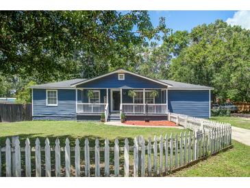 Charming blue home with a white picket fence and front porch at 116 Cone Ln, Summerville, SC 29483