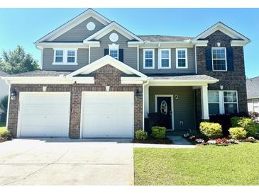 Beautiful two-story home featuring a two-car garage, brick accents, and a well-manicured lawn at 1333 Song Sparrow Way, Hanahan, SC 29410