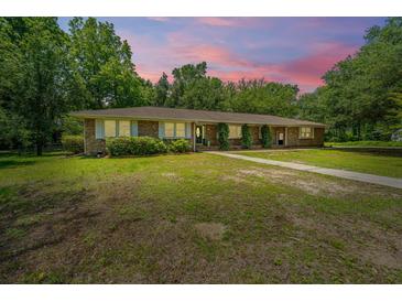 Charming brick home with mature trees, lush landscaping and a spacious yard at 1655 Pinckney Park Dr, Charleston, SC 29407