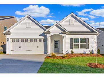 Charming single-story home with a two-car garage, manicured lawn, and classic white siding at 1671 Grange Cir, Summerville, SC 29486