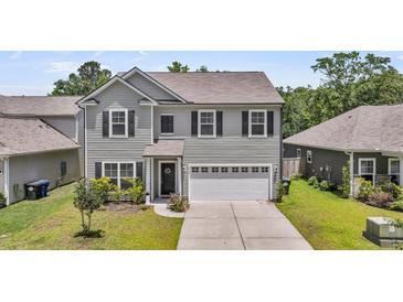 Charming two-story home featuring a two-car garage, well-maintained lawn, and attractive landscaping at 2109 Rowan Rd, Johns Island, SC 29455