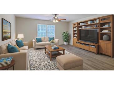 Inviting living room features stylish furniture, area rug, and a built-in entertainment center with bookshelves at 2150 Spoleto Ln # H2, North Charleston, SC 29406