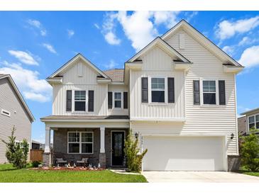Charming two-story home features a welcoming front porch, attached garage, and classic curb appeal at 2746 Sunrose Ln, Johns Island, SC 29455