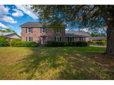 Charming two-story brick home with a well-manicured lawn and mature trees at 305 Whitewood Ct, Moncks Corner, SC 29461