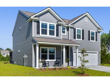 Charming two-story home with gray siding, black shutters, and a well-manicured front lawn at 5115 Cranesbill Way, Johns Island, SC 29455