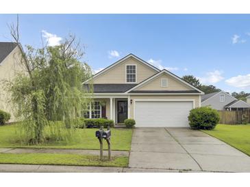 Charming single-story home with a manicured lawn and a two-car garage in a suburban neighborhood at 108 Larkspur Dr, Goose Creek, SC 29445