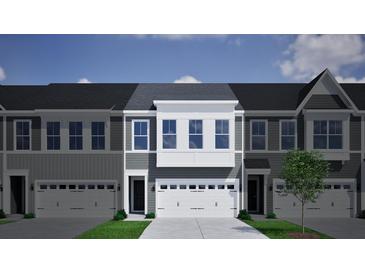 Charming townhome featuring a two-car garage, gray siding, and large windows that add natural light at 120 Brown Swiss Cir, Summerville, SC 29483