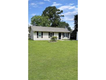 Charming single-story home with a well-manicured lawn and classic curb appeal at 1207 Saint Johns Ave, Moncks Corner, SC 29461