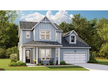 Charming two-story home features a welcoming front porch, attached garage, and well-manicured lawn at 212 Yalton St, Summerville, SC 29486