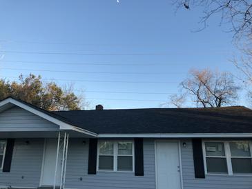 Charming home with a new black roof, light gray siding, black shutters and white doors at 2317 Elegans Drive Dr, North Charleston, SC 29405
