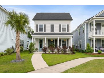 Charming two-story home with a welcoming front porch, landscaped yard, and beautiful curb appeal at 2747 Calico Bass Ln, Johns Island, SC 29455
