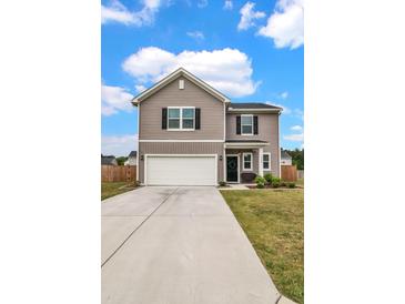 Attractive two-story home with a spacious driveway, well-maintained lawn, and charming curb appeal at 716 Mcroy St, Moncks Corner, SC 29461