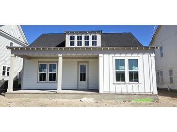 Charming single-story home with a covered porch, white siding, and a dormer window at 827 Gentle Breeze Dr, Summerville, SC 29486