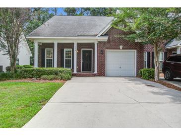 Charming brick home featuring a well-manicured lawn, single-car garage, and inviting front porch with white columns at 116 Venezia Ct, Ladson, SC 29456
