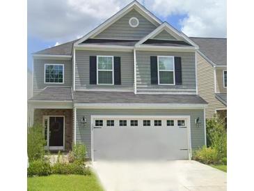 Charming two-story home featuring gray siding, black shutters, and a two-car garage at 127 Longford Dr, Summerville, SC 29483