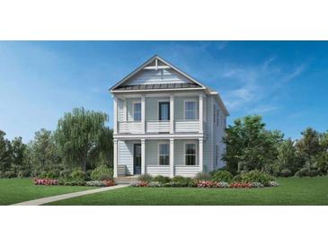 Charming two-story home with double balconies, craftsman details, and a beautifully landscaped front yard at 128 Falaise St, Charleston, SC 29492