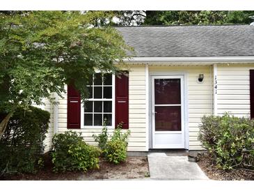 Charming home featuring red shutters and a well-maintained front yard with lush greenery at 1341 Pinnacle Ln, Charleston, SC 29412