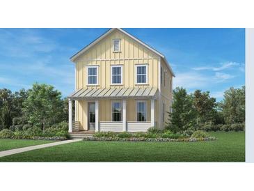 Charming two-story home with a covered porch and well-manicured lawn on a sunny day at 140 Falaise St, Charleston, SC 29492