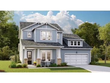 Charming two-story home featuring light blue siding, a welcoming front porch, and an attached two-car garage at 214 Callibluff Dr, Summerville, SC 29486