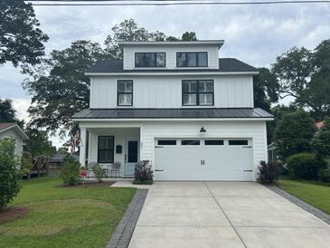 Charming, modern farmhouse with a two-car garage and professionally landscaped yard at 31 Wedgepark Rd, Charleston, SC 29407
