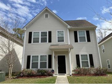 Charming two-story home with landscaped yard and classic architectural details at 4936 Ballantine Dr, Summerville, SC 29485