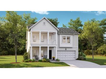 Charming two-story home featuring a welcoming front porch and a two car garage at 1034 Scotch Bonnet Way, Summerville, SC 29485