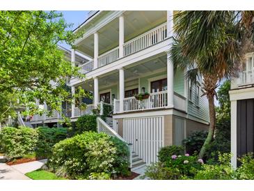 Two story beach house featuring porches with white columns and lush landscaping at 158 Mary Ellen Dr, Charleston, SC 29403