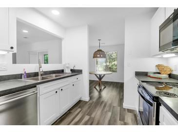 Bright eat-in kitchen featuring stainless steel appliances and updated cabinets at 202 Waterwood Dr, Goose Creek, SC 29445
