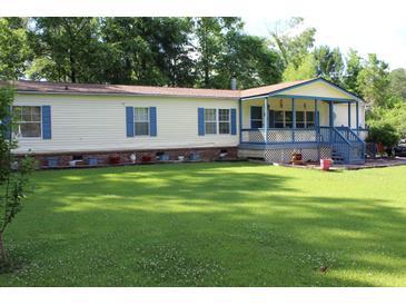 Charming single-story home with a welcoming porch and a spacious, well-maintained front yard at 204 Pete Ewers Dr, Summerville, SC 29483