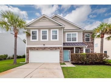 Two-story home with stone and siding accents, light blue door, palm trees, and an attached garage at 228 Donatella Dr, Goose Creek, SC 29445