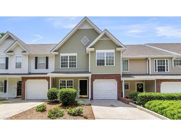 Inviting townhouse with a single-car garage and well-manicured landscaping at 230 Darcy Ave, Goose Creek, SC 29445
