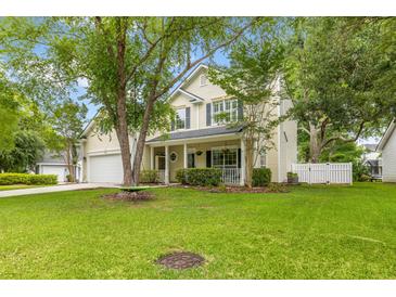 Inviting two-story home featuring a well-manicured lawn and mature trees creating a warm curb appeal at 261 Mossy Oak Way, Mount Pleasant, SC 29464