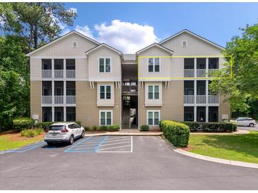 Well-maintained condo building with a tan exterior and spacious screened balconies at 2632 Egret Crest Ln, Charleston, SC 29414